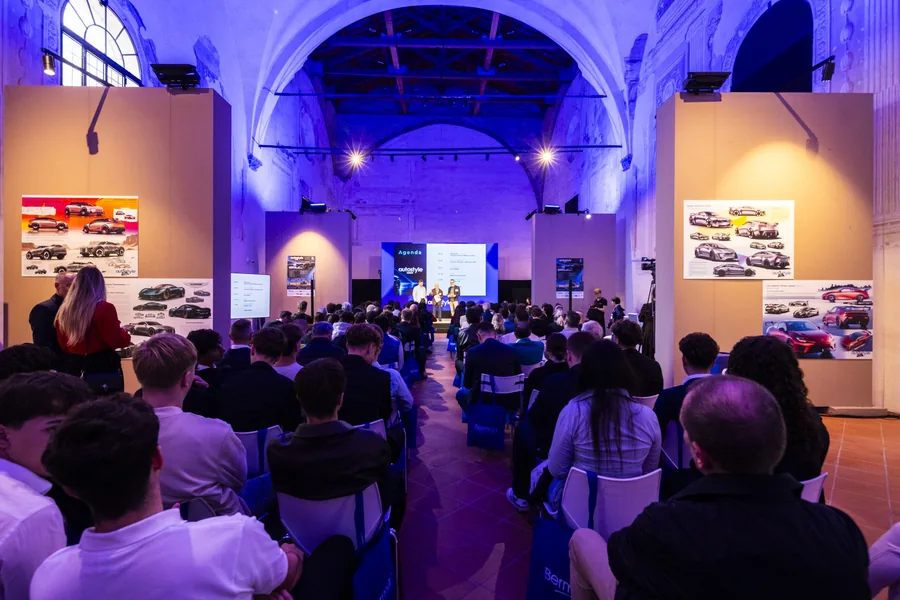 Audience and display boards in a historic hall at the Autostyle Design Competition 2026 with Ducati