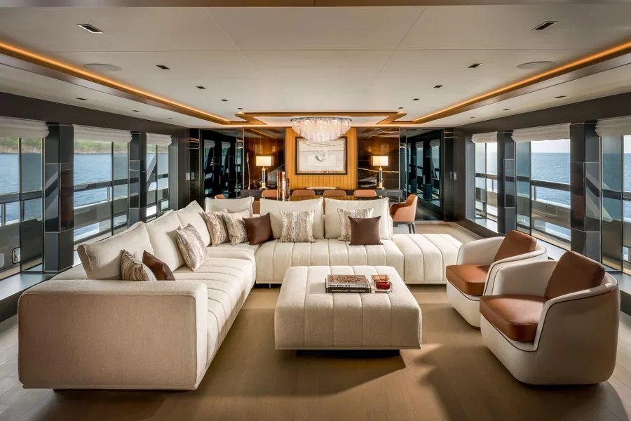 Main salon of the Riva 54Metri with light sofas, wood and full height windows